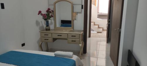 a bathroom with a sink and a mirror at Hotel Mykonos Manta in Manta