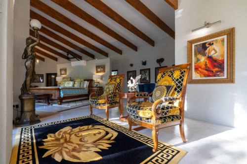 a living room with chairs and a table at Oase by 7 Star Lodges - Greater Kruger Private 530ha Reserve in Hoedspruit