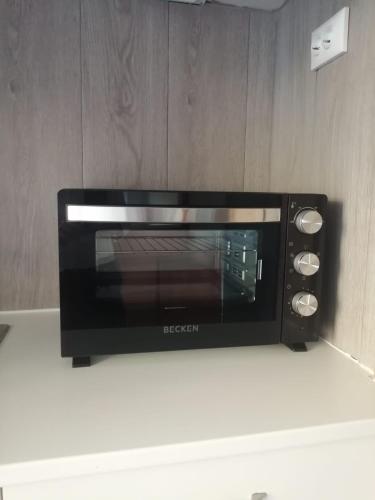 a black microwave sitting on top of a counter at The Pearl of Lisbon in Lisbon