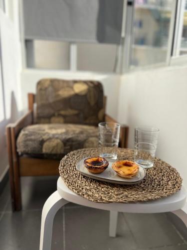 a table with two plates of food on a table with a chair at The Pearl of Lisbon in Lisbon
