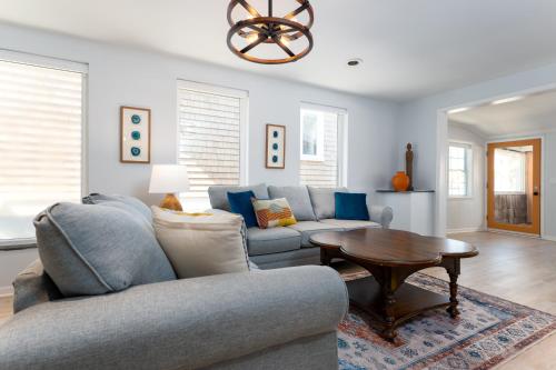 a living room with a couch and a table at Be A Nomad Laid Back Beach Home in Jacksonville Beach
