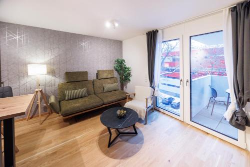a living room with a couch and a table at Zoder Apartments in Vienna