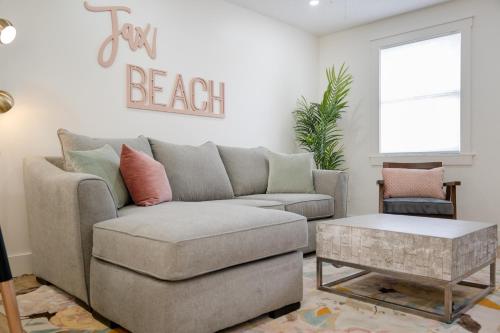 a living room with a couch and a table at Be A Nomad Lovely 2br 1blk from the Ocean in Jacksonville Beach