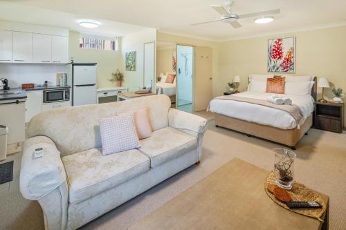 a living room with a couch and a bed at The Guesthouse Maleny in Maleny