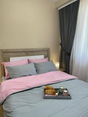 a tray of food sitting on top of a bed at APARTMAN 94 in Zlatibor