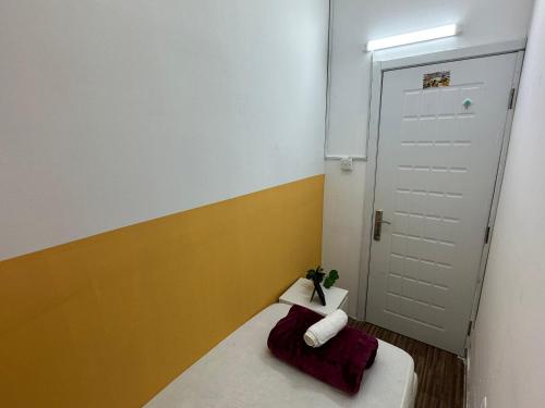 a small room with a bed and a door at Wonderful Partition Room in Al Barsha 1 Near Metro in Dubai