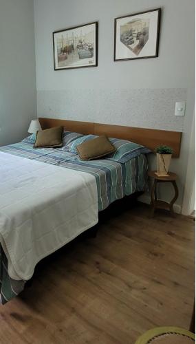 a bed with two pillows on it in a room at Atibaia Racanto Tranquilo in Atibaia