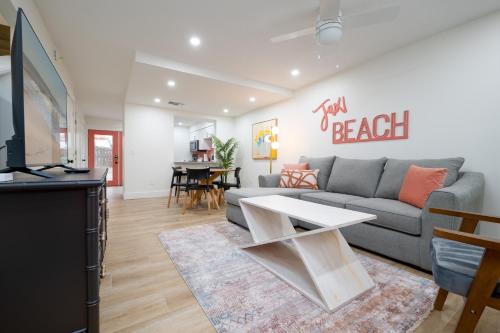 a living room with a couch and a table at Be A Nomad Lovely 2br 1blk from the Ocean in Jacksonville Beach