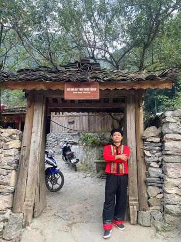 a man standing in front of a wooden structure at 305HA Gest house in Ninh Binh