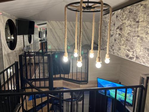 a room with a table and chairs and a chandelier at Villazul 1 in Poás