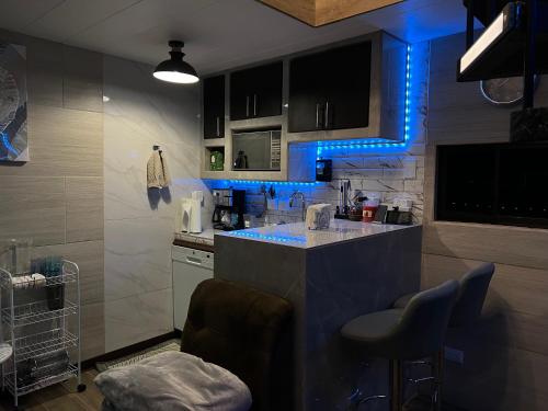 a kitchen with blue led lights on the counters at Villazul 1 in Poás