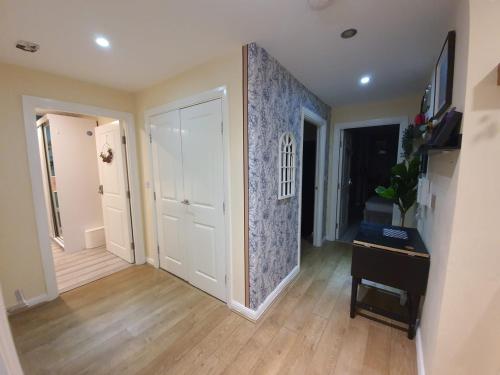 a room with a hallway with a door and a wall at Wallwood Rooms in London
