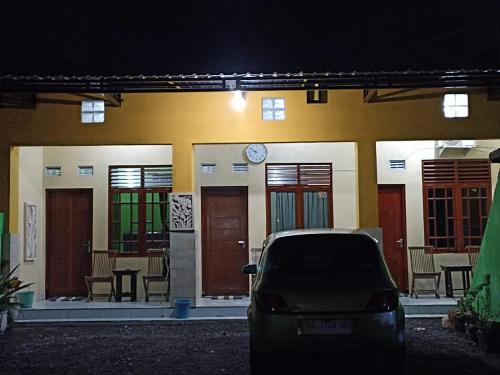 a car parked in front of a building at night at Penginapan Ana Indah in Borobudur