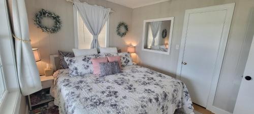 a bedroom with a bed with pillows on it at Waterfront, dock, Hot tub, kayaks, King Bedroom with amazing views, RELAXATION, 2 miles to the beach in Cedar Point