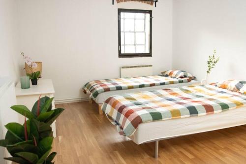 a bedroom with two beds and a window at Historical Malt Factory Apartment, 6 Bedrooms, sleeps 12 , Hot Tub in Helsingborg