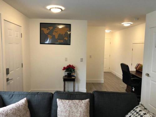 a living room with a blue couch and a desk at ChrisTon Exotic Suite - A Homey Suite in Halifax