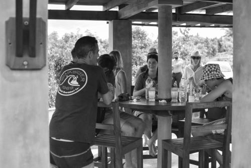 a group of people sitting at a picnic table at Ceylon Nature Paradise in Uragasmanhandiya