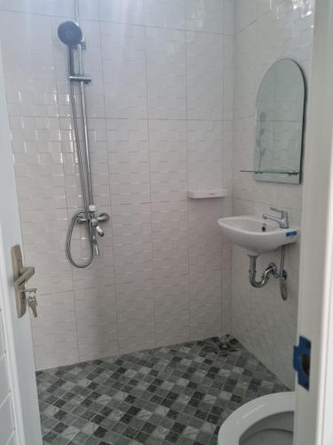 La salle de bains est pourvue d'une douche, d'un lavabo et de toilettes. dans l'établissement Diyan Padhang Homestay Kamar5, à Jetis