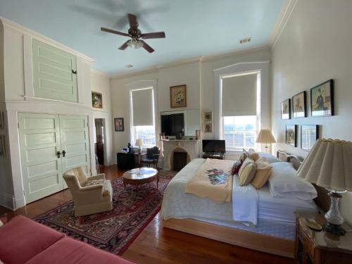 a bedroom with a large bed and a living room at Bazsinsky House in Vicksburg