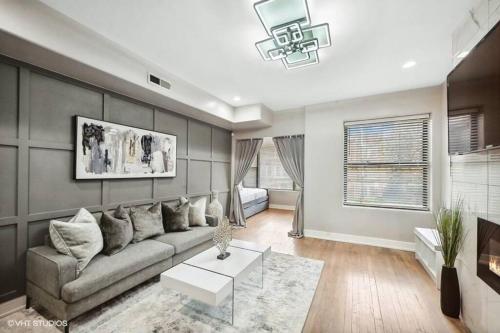 a living room with a couch and a table at The Chic Urban Oasis Near the Lake! in Chicago