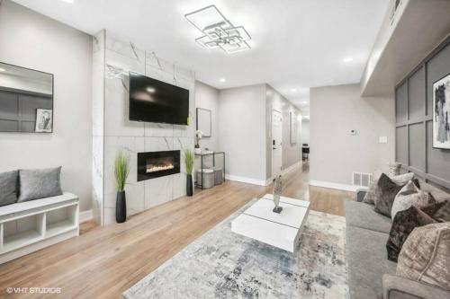 a living room with a couch and a fireplace at The Chic Urban Oasis Near the Lake! in Chicago
