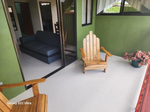 a living room with a chair and a couch at Peluza's place in Puerto Jiménez