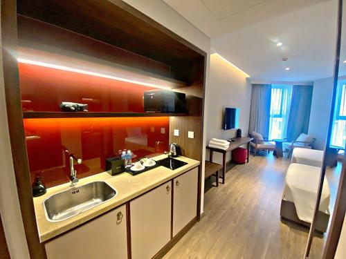 a hotel room with a kitchen and a living room at Apec Mandala Cham Bay Mui Ne 5* in Ấp Thiẹn Ái