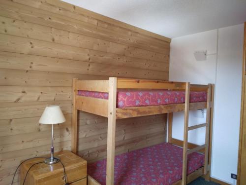 a bunk bed in a room with a lamp at Appartement fonctionnel au cœur des pistes avec balcon et accès piscine - FR-1-181-2786 in La Plagne Tarentaise