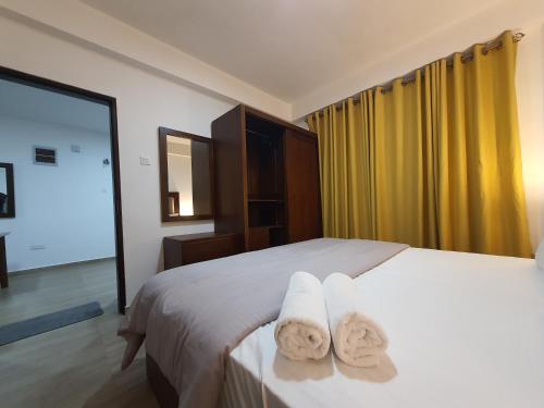 a hotel room with a bed with towels on it at Green Mount View Two Bed Room Apartment in Nuwara Eliya