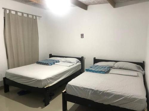 two beds sitting next to each other in a room at Casa en playa los Chimus / Samanco / Ancash in Tortuga