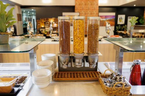 a counter with three tall glass containers filled with food at Mercure Kakadu Crocodile in Jabiru