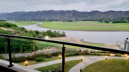 a view of a river from a balcony at Departamento frente a lago Carlos Paz - Villa Siquiman - Complejo Veneto Village in Villa Parque Siquiman