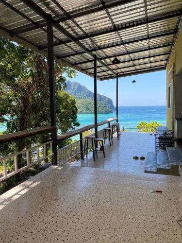 a view of the ocean from the porch of a house at The view Hostel in Phi Phi Don