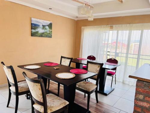 a dining room with a table and chairs at Mphatlalatsane BnB in Maseru