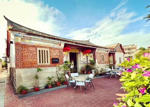 a patio with tables and chairs outside of a building at I-Shan B&B in Jincheng