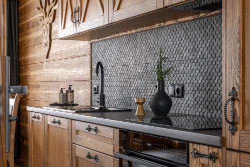 a kitchen with a sink and a counter with a vase at Willa Polana pod Nosalem in Zakopane