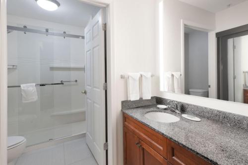 a bathroom with a sink and a shower at Residence Inn by Marriott Rogers in Rogers