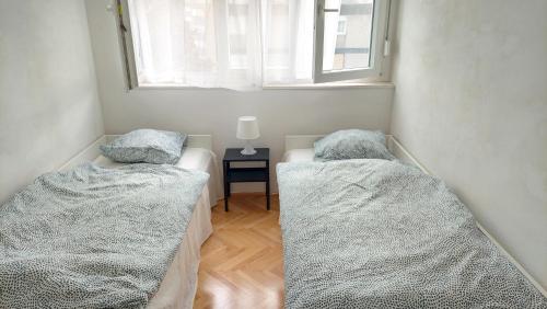 two beds in a room with a window at Apartment Matilda in Split