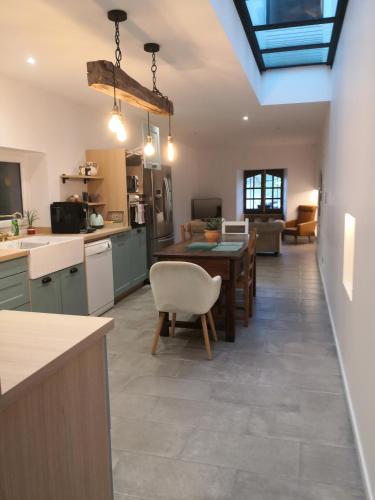 une cuisine et un salon avec une table et des chaises dans l'établissement Gites Mendiburia, à Iholdy