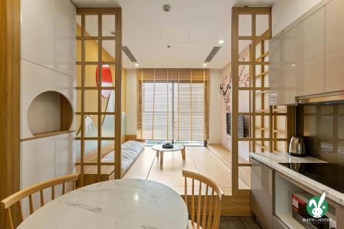 a kitchen with a table and chairs in a room at Bunny Bliss-Service Apartment in Hanoi