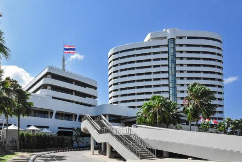 a large white building with stairs in front of it at Rua Rasada Hotel - The Ideal Venue for Meetings & Events in Trang