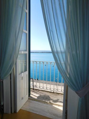a view of the ocean from a room with a window at Camere A’ Marina in Siracusa