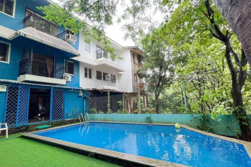 an image of a swimming pool in front of a house at 4bhk cabin in the woods- Lonavala in Lonavala