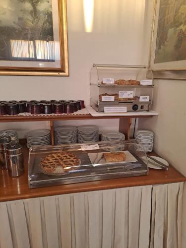 a buffet with pizzas and plates on a counter at Hotel Internazionale in Cervignano del Friuli