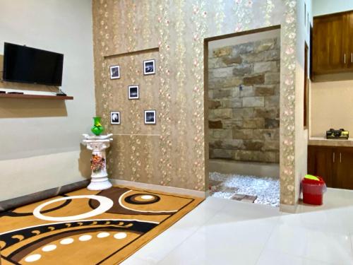 a living room with a wall with a fireplace at DMoon Villa in Yogyakarta