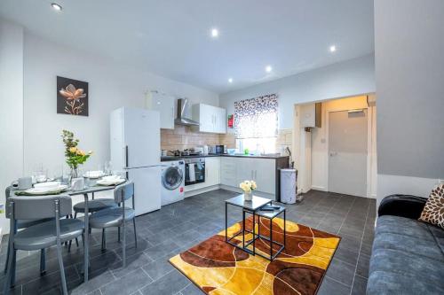 a kitchen and living room with a table and a couch at *372kr* For your most relaxed & Cosy stay + Free Parking + Free Fast WiFi * in Headingley
