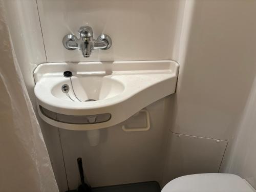 a bathroom with a sink and a toilet at Room137 Stay in Stoke Newington in London
