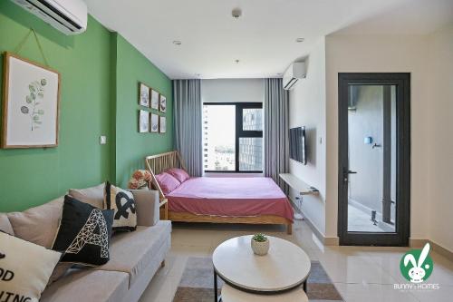 a living room with a couch and a bedroom at Bunny Bliss-Service Apartment in Hanoi