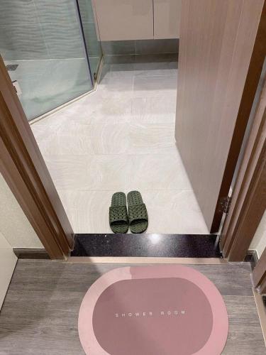 a pair of shoes on the floor of a bathroom at Bunny Bliss-Service Apartment in Hanoi
