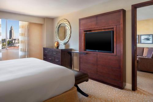 a hotel room with a bed and a flat screen tv at The Lincoln Marriott Cornhusker Hotel in Lincoln